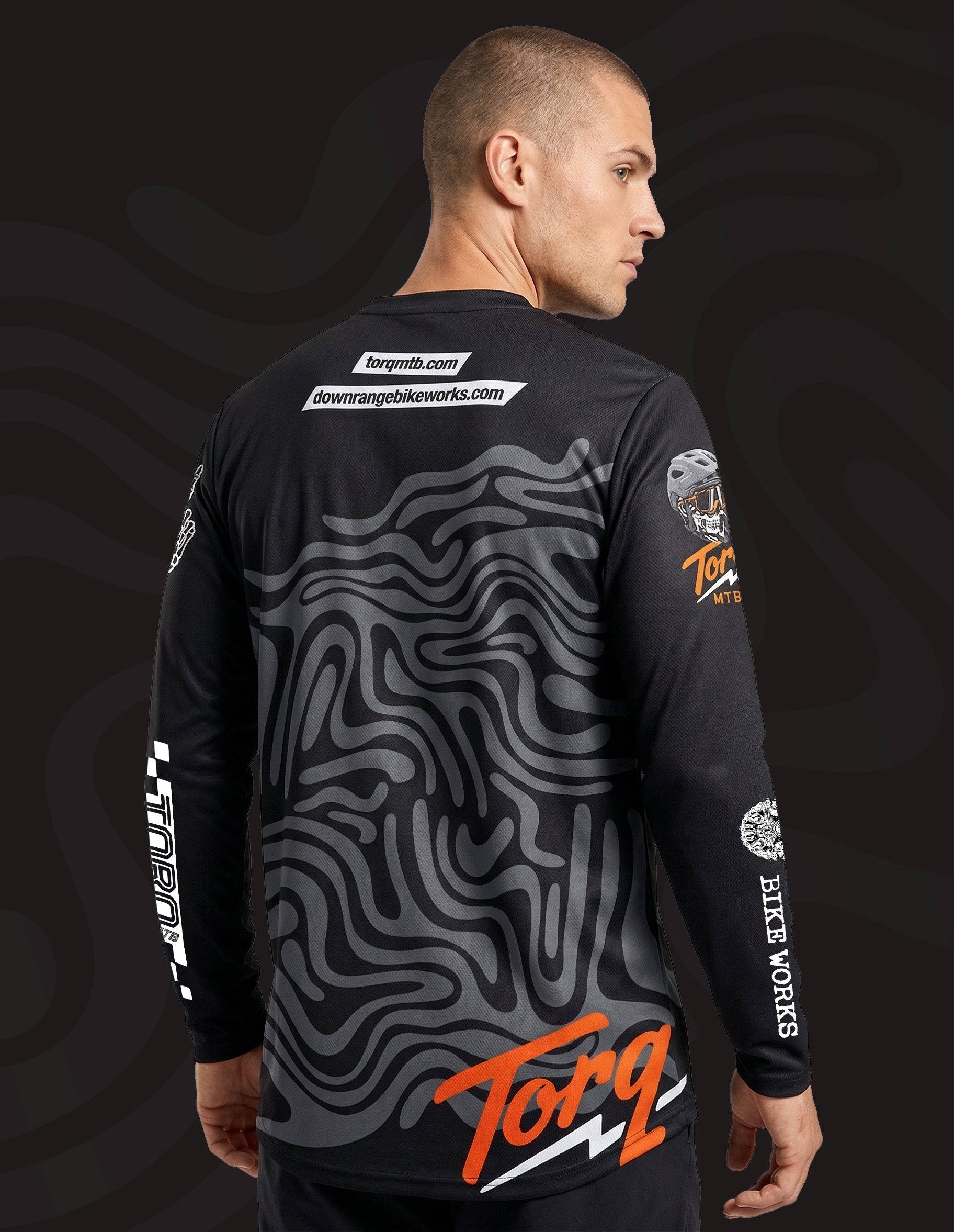 Torq MTB Downrange Jersey featuring a rider wearing a lightweight, moisture-wicking mountain biking jersey with bold graphics.